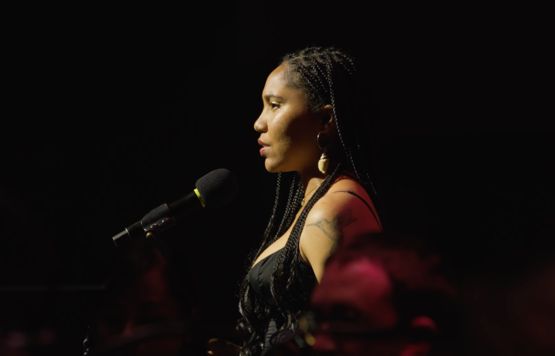 Johanna Gibson reading at a microphone
